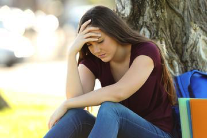 Description: Concerned student lamenting outdoors